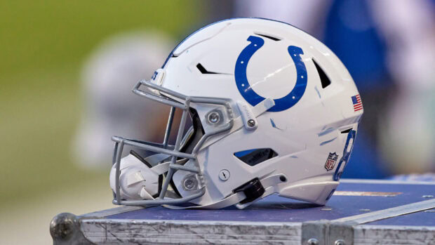 A close up of an Indianapolis Colts football helmet resting on a table