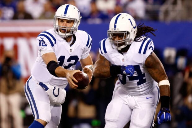 Indianapolis Colts players executing a handoff during an intense football game