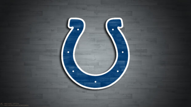 Blue Indianapolis Colts logo on a wooden floor background with a shadow effect