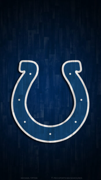 A blue horseshoe logo on a dark wooden background representing Indianapolis Colts