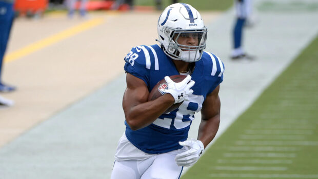 Indianapolis Colts player running with the ball during a game on the field