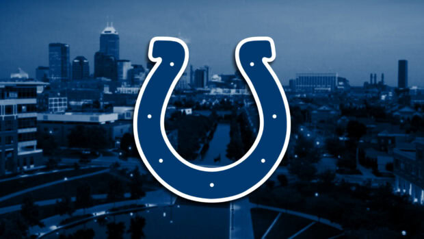 The Indianapolis Colts logo over a blue tinted cityscape of Indianapolis