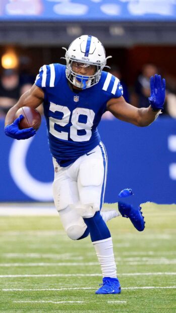 Indianapolis Colts player running with the ball during a football game on the field