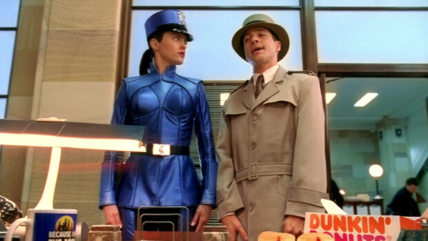 A detective and a woman in a blue uniform are standing side by side indoors, HD Desktop Wallpaper