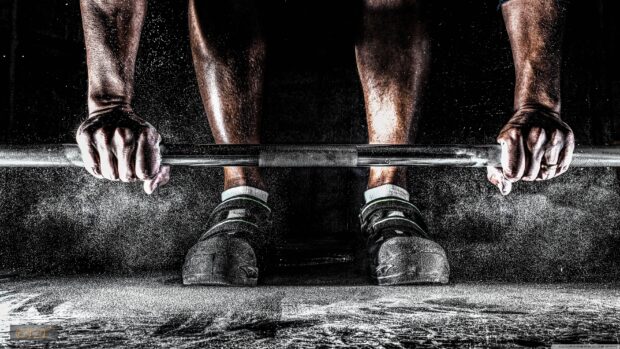 A close up of hands gripping a barbell with chalk dust during Crossfit training, 2K Desktop Wallpaper