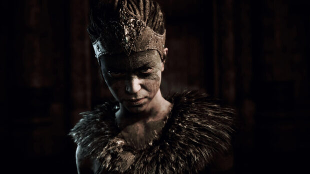 A fierce Hellblade character wears a decorated crown and fur cloak with a determined expression, 4K Desktop Wallpaper