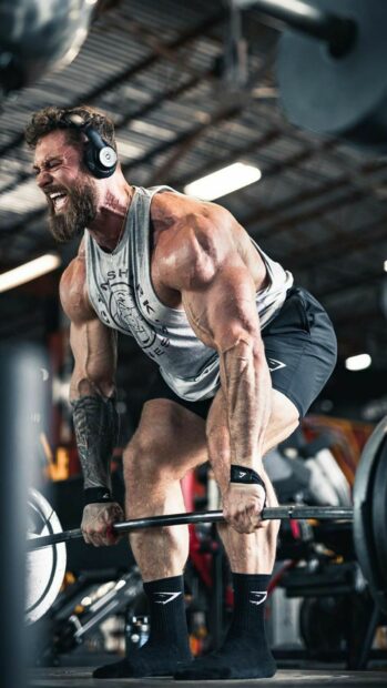 A muscular man is performing a heavy deadlift in the gym with full effort, HD Phone Wallpaper
