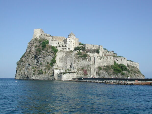 A historic fortress on a rocky island surrounded by the sea in Ischia