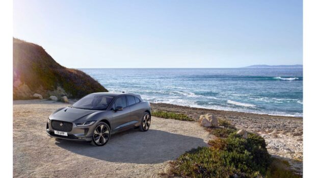 A Jaguar I Pace is parked near coastal cliffs with the ocean in the background, HD Desktop Wallpaper