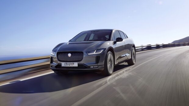 A black Jaguar I Pace is driving fast on a curved coastal road, 4K Desktop Wallpaper