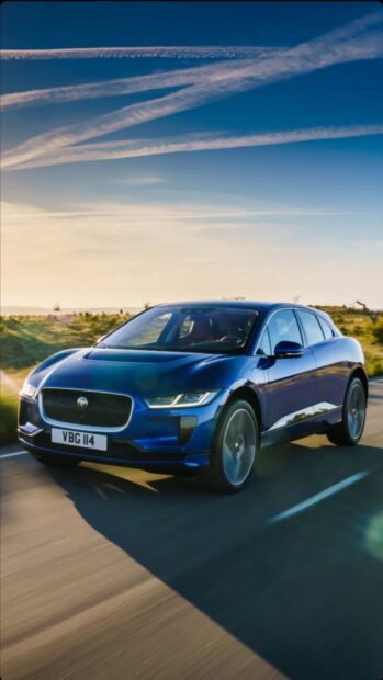 A blue Jaguar I Pace is driving on a sunny road with clear skies, HD Phone Wallpaper