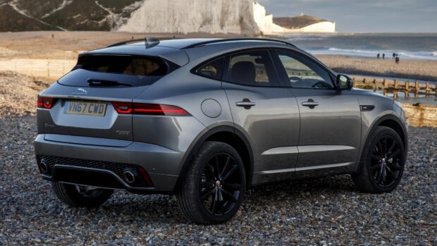 A gray Jaguar I Pace is parked on a rocky shore near the ocean and cliffs, HD Desktop Wallpaper