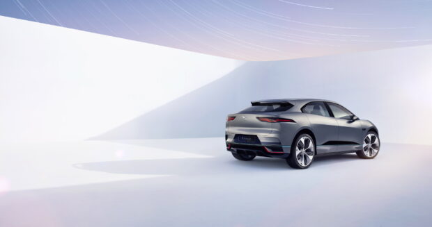 A silver Jaguar I Pace is shown from the rear in a modern minimalistic setting, 2K Desktop Wallpaper
