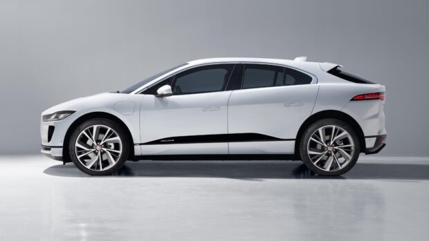 A white Jaguar I Pace electric car is parked on a smooth surface viewed from the side, 4K Desktop Wallpaper
