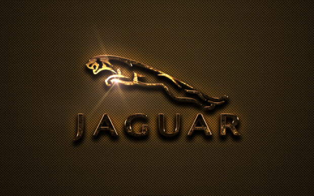 A shiny golden jaguar logo with a reflective texture on a dark patterned background