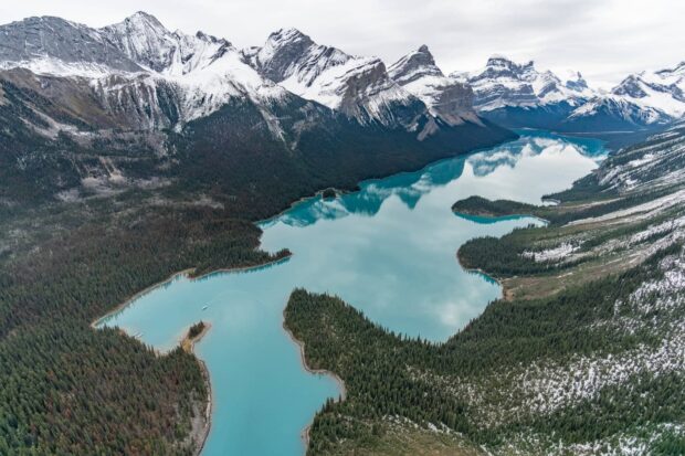 Snow capped mountains and turquoise lake in Jasper National Park landscape