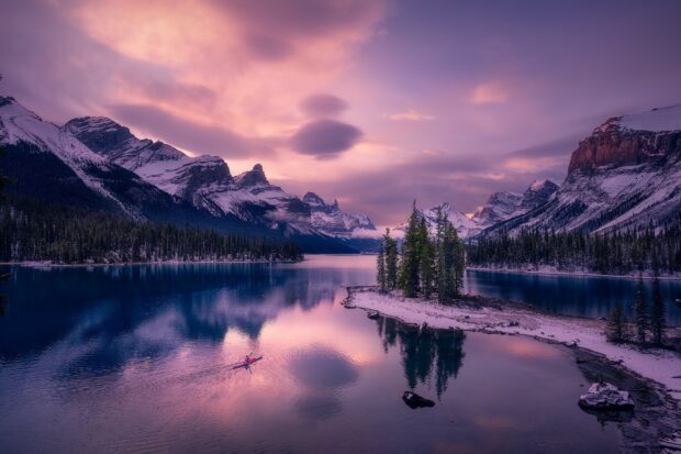 Snowy mountain landscape with forest and lake in Jasper National Park at sunset