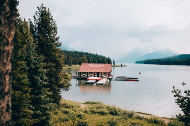 Maligne Lake boat house surrounded by forest and mountains in Jasper National Park