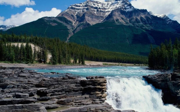 A clear view of mountain landscape with river and trees in Jasper National Park