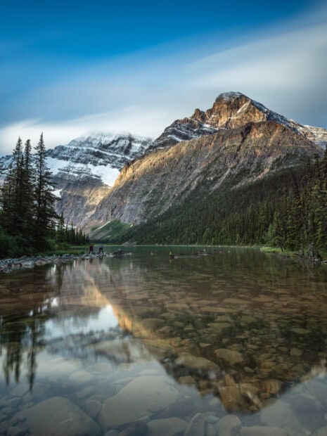 A scenic mountain landscape with rocky peaks and evergreen trees in Jasper National Park