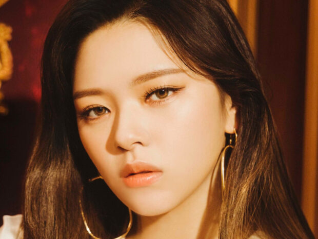 A close up portrait of Jeongyeon from Twice with warm lighting and large hoop earrings, HD Mobile Wallpaper