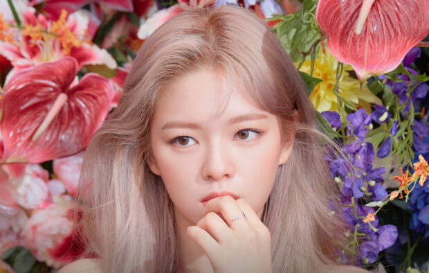 A close up portrait of Jeongyeon from Twice surrounded by colorful flowers, HD Desktop Wallpaper