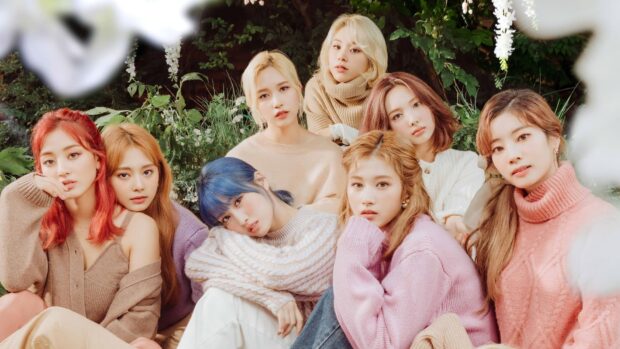 A group photo featuring Jeongyeon Twice members in soft pastel sweaters with a floral background, HD Desktop Wallpaper