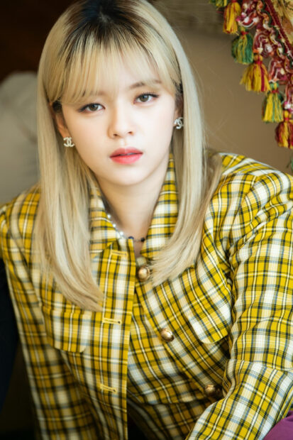 Jeongyeon Twice is wearing a yellow plaid jacket and looking directly at the camera, 2K Mobile Wallpaper