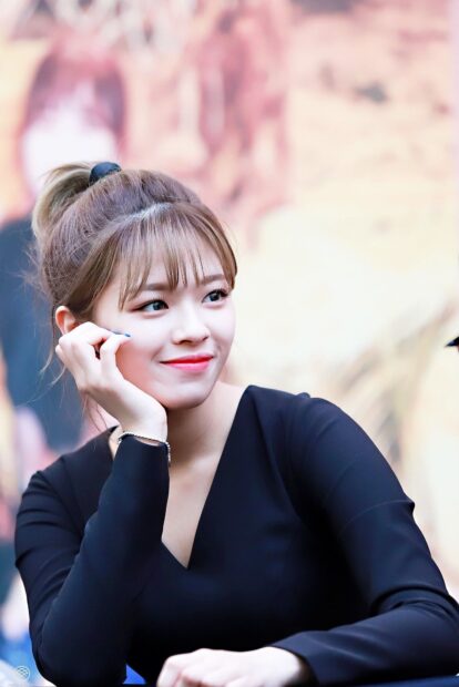 Jeongyeon Twice is sitting with her hand resting on her face wearing a black outfit, HD Mobile Wallpaper