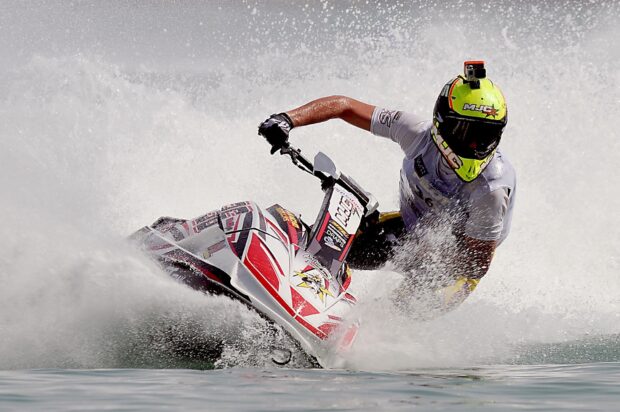 A person riding a jet ski swiftly cuts through water spray, HD Desktop Wallpaper