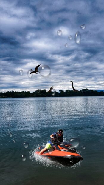 A person rides a jet ski across a calm lake under a cloudy sky, 2K Phone Wallpaper
