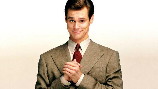 Jim Carrey smiles confidently in a brown suit with a red tie, HD Desktop Wallpaper