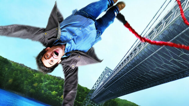 Jim Carrey falling in a blue shirt near a bridge over water, HD Desktop Wallpaper