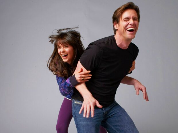 Jim Carrey shares a joyful moment with a woman while laughing together, 2K Desktop Wallpaper