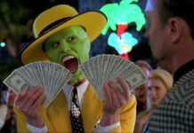 Jim Carrey holding fans of dollar bills with a shocked expression, HD Desktop Wallpaper