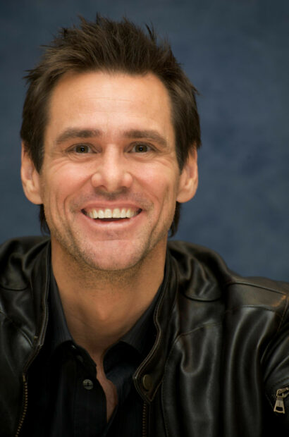 Jim Carrey smiles brightly in a close up portrait wearing a black jacket, 2K Mobile Wallpaper