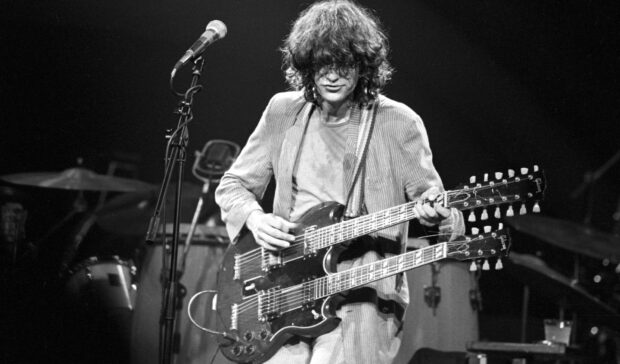 Jimmy Page playing a double neck guitar on stage during a concert live performance