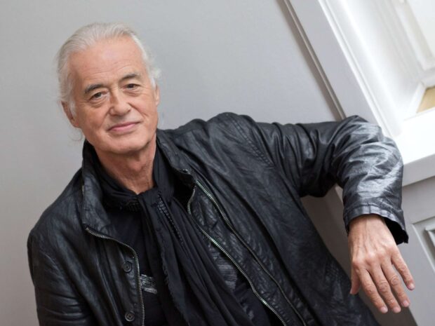 Jimmy Page in a black leather jacket posing indoors with a relaxed expression