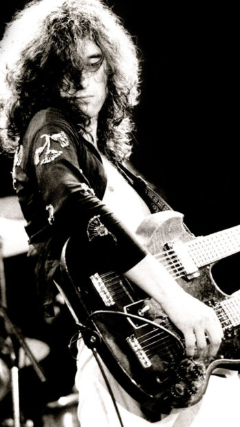 Jimmy Page playing a double neck guitar during a live performance