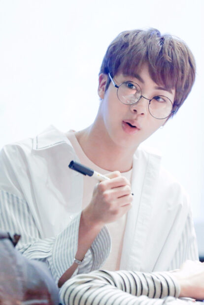 Jin BTS wallpapers shows him holding a pen and wearing round glasses, HD Mobile Wallpaper
