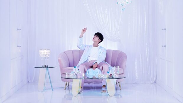 Jin Bts Wallpapers shows a man sitting on a purple couch surrounded by glass decor, HD Desktop Wallpaper