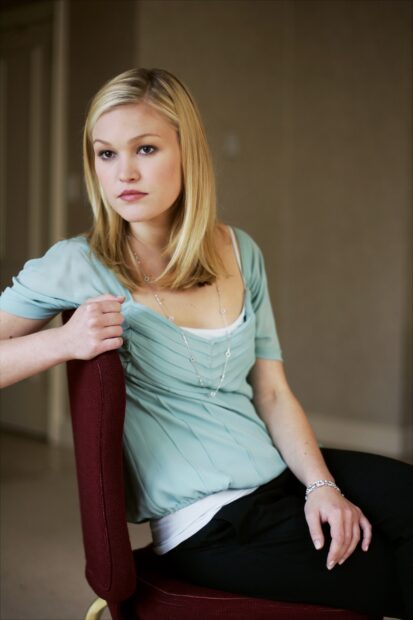A young woman wearing a light blue top sitting thoughtfully on a red chair, HD Mobile Wallpaper