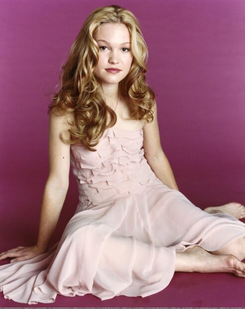 Julia Stiles Wallpapers featuring a woman seated with flowing hair against a purple background, HD Mobile Wallpaper