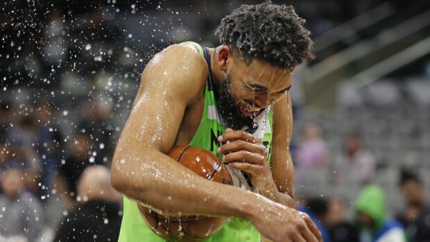 Karl Anthony Towns celebrating with a basketball during a game splash