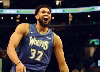 Karl Anthony Towns celebrating on the basketball court in a Wolves jersey
