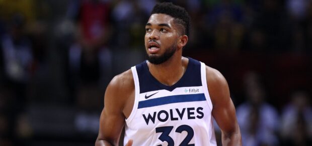 Karl Anthony Towns is focused during a basketball game wearing his Wolves jersey number 32