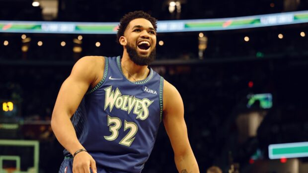 Karl Anthony Towns celebrating on the basketball court in a Wolves jersey