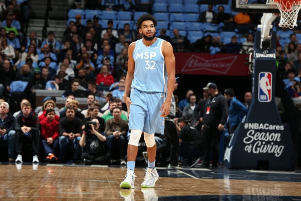Karl Anthony Towns standing on the basketball court wearing a blue MSP jersey 32
