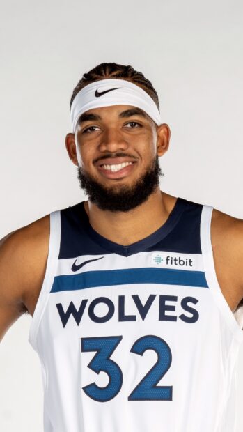 Karl Anthony Towns wearing his Wolves jersey with number 32 and a white headband