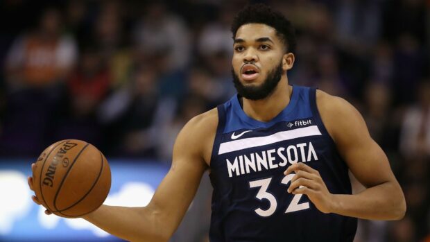 Karl Anthony Towns playing basketball for Minnesota with a focused expression